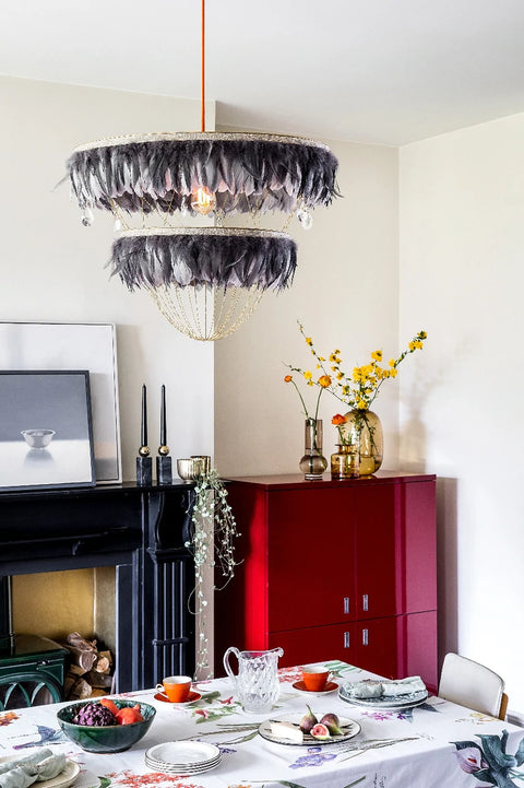 Grey feather chandelier above dinning table. Dining room lighting